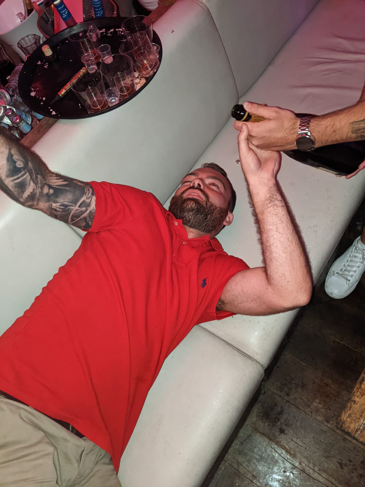 An earlier photograph of Nathan wearing a red polo shirt on a night out